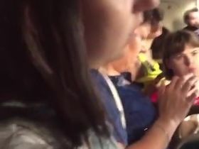 Парень едет в автобусе и снимает на камеру телефона молодую девушку в коротком платье